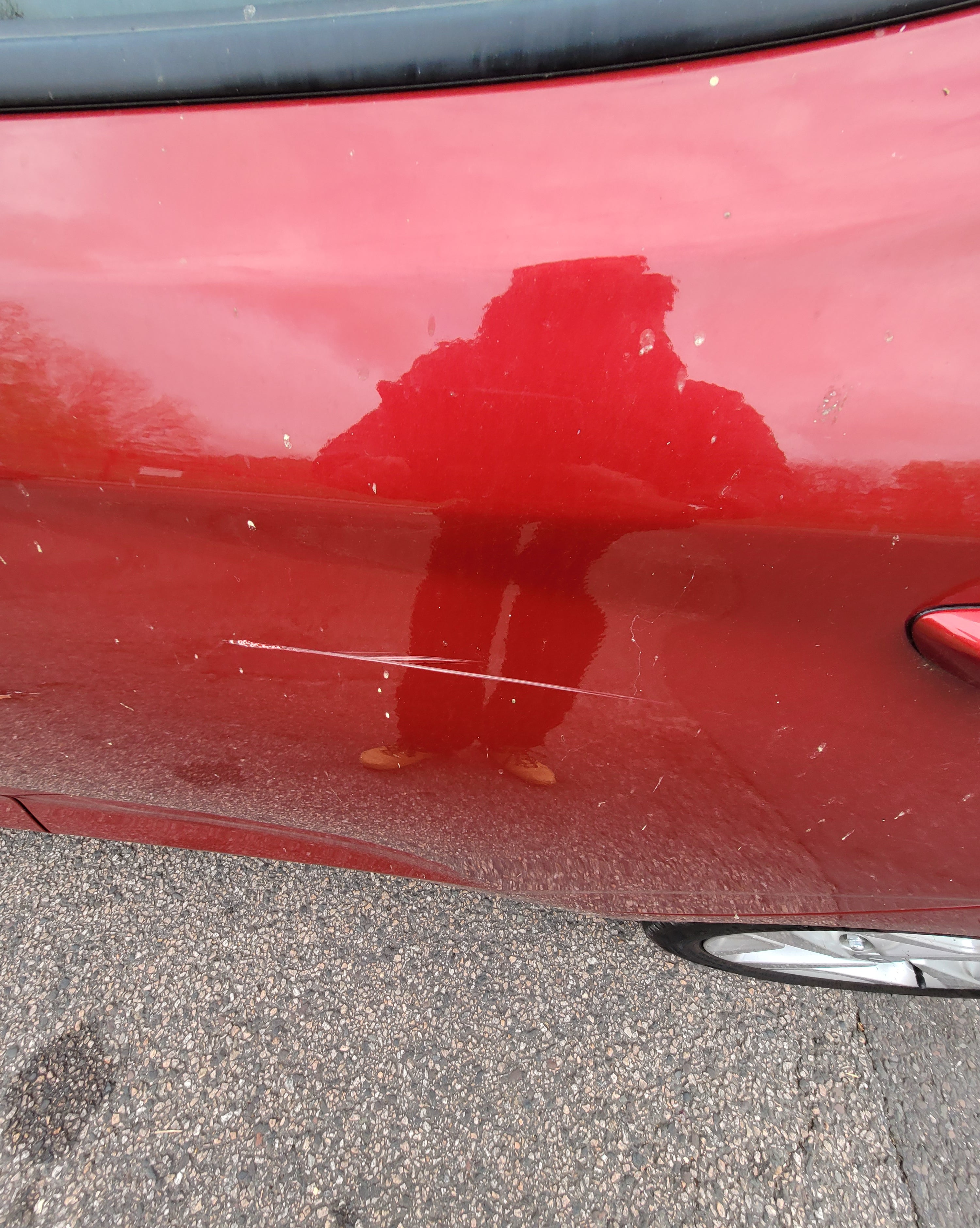 Red car with a small dent on the side