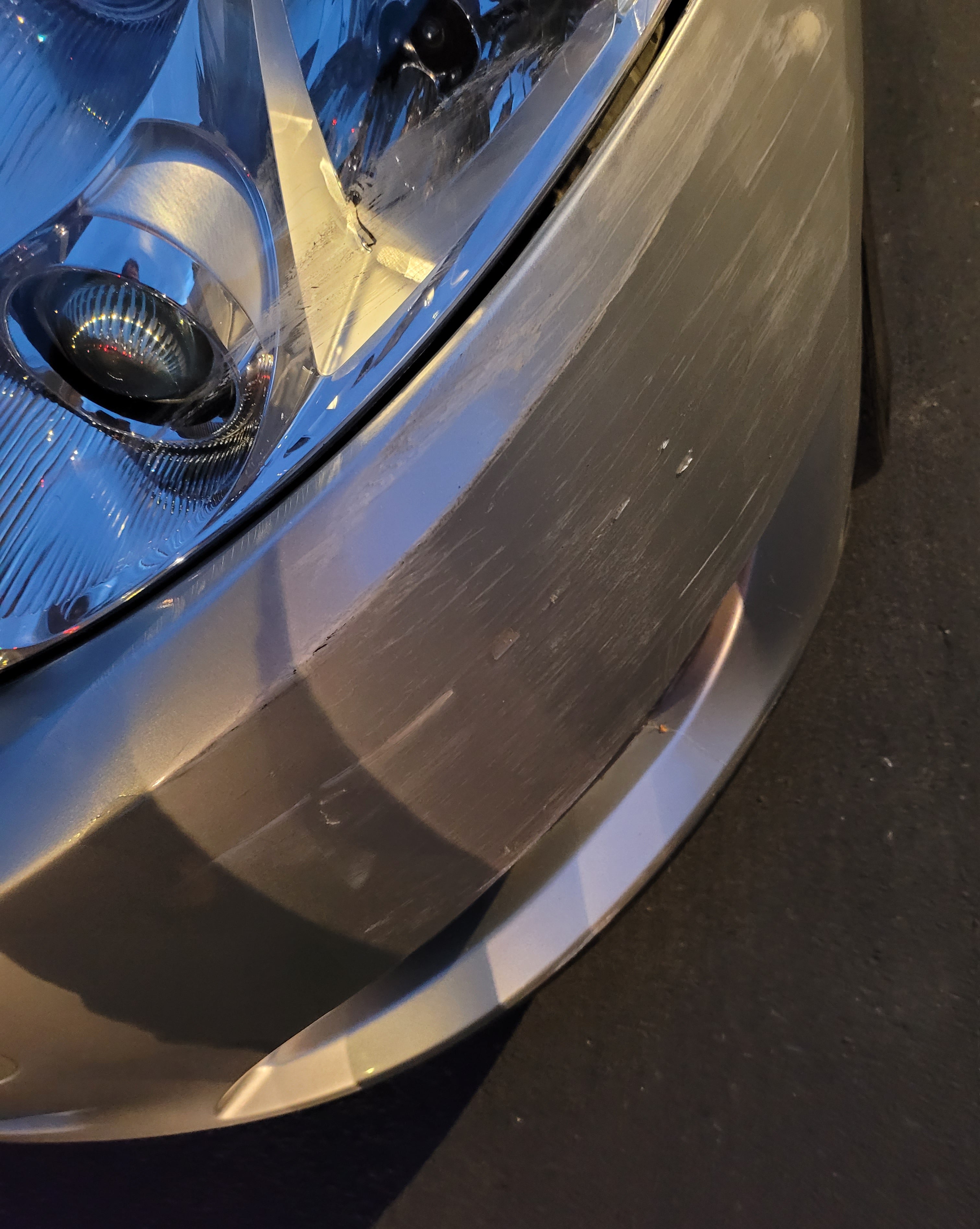 Close-up of a car headlight with a dark background