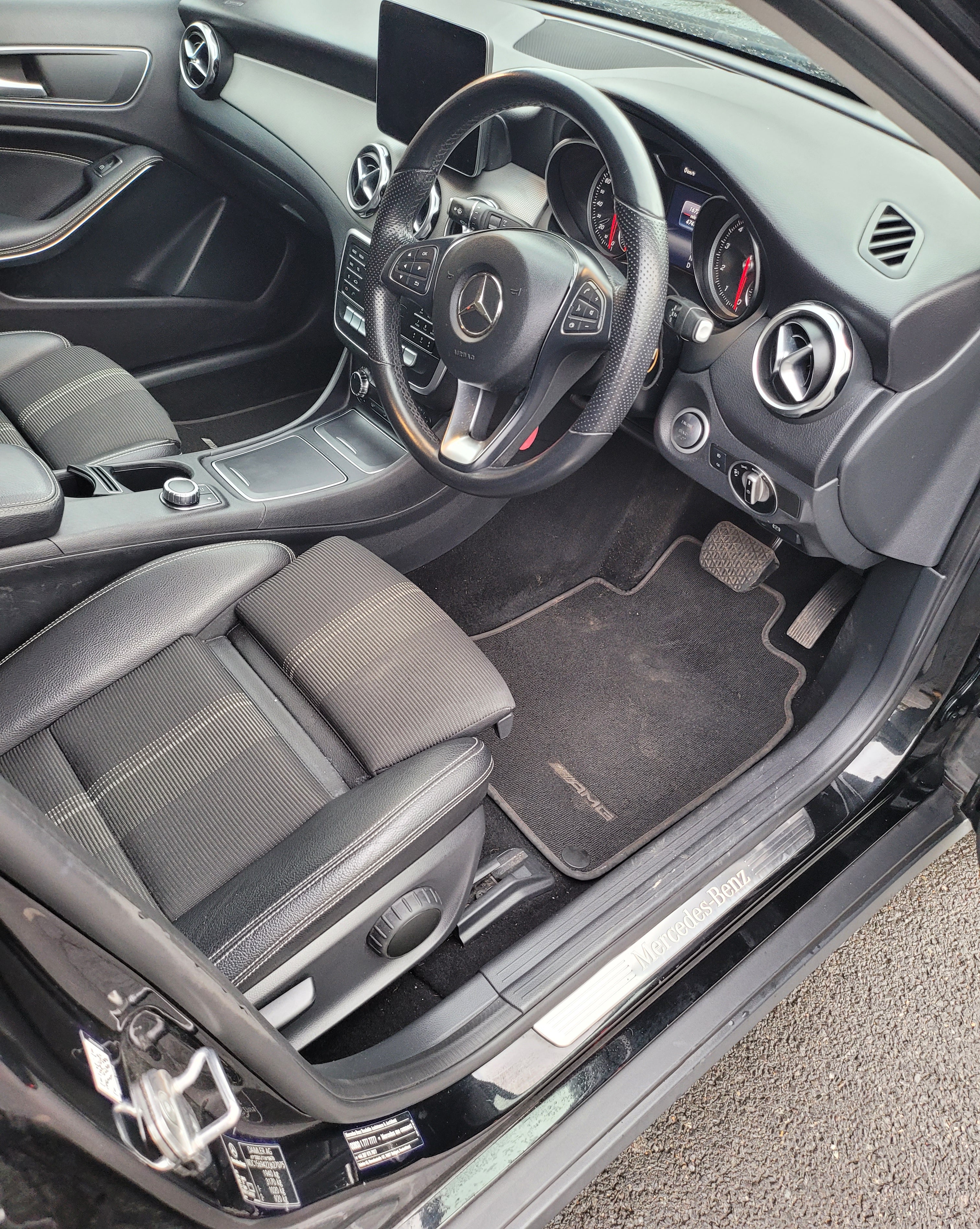 Car interior with steering wheel and dashboard view