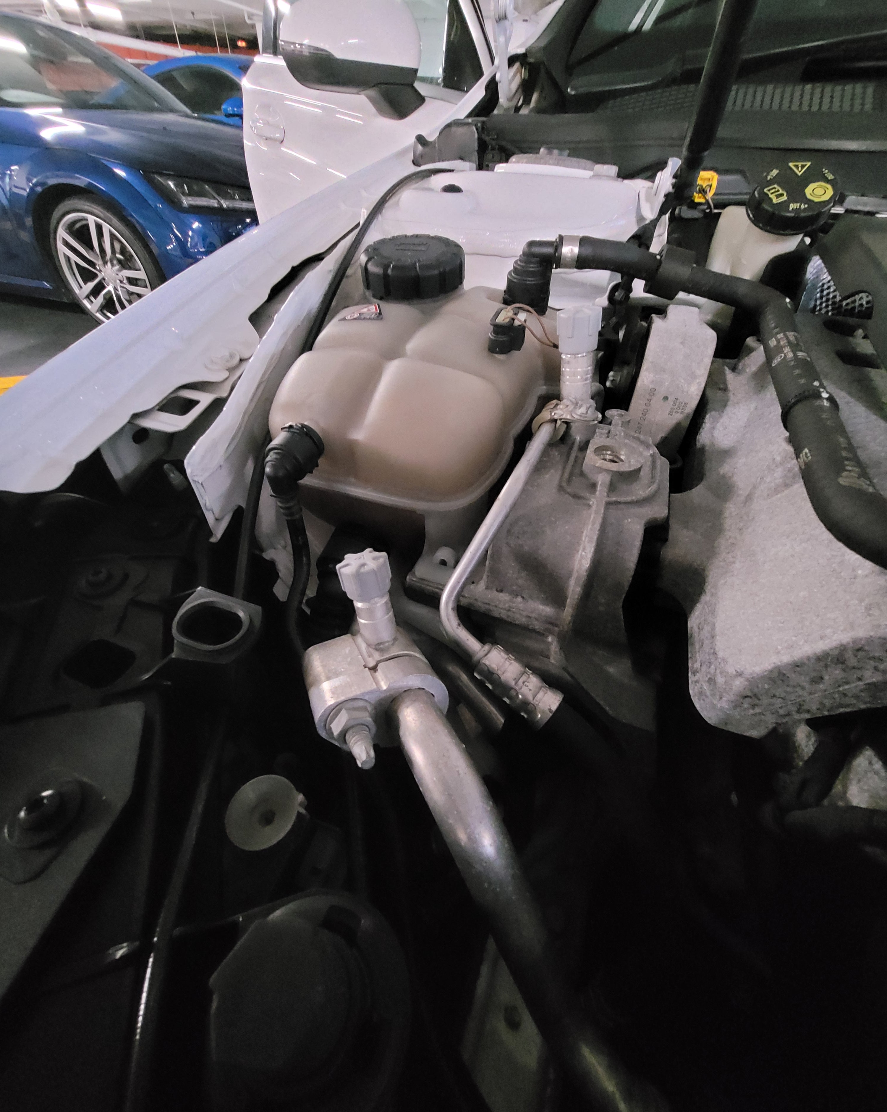 Close-up of a car's undercarriage with visible mechanical components.