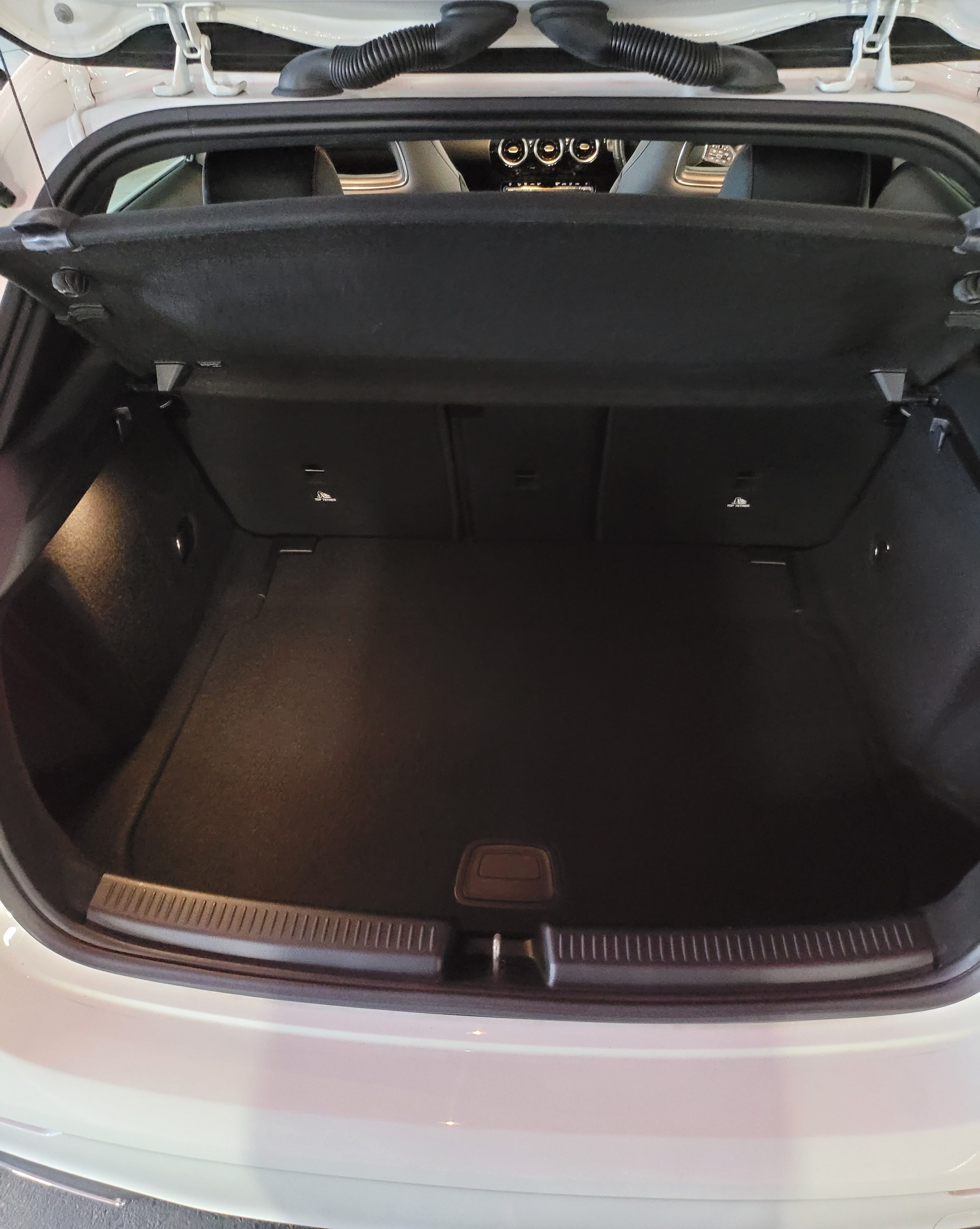 Open car trunk with a black mat inside